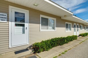A row of single-story buildings with numbered doors, indicating individual units.