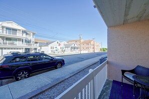 A residential street with a parked SUV, houses, and a clear sky. - Walk to Beach! Updated Brigantine Retreat (Brigantine)