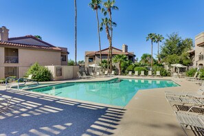 A swimming pool with lounge chairs and palm trees. - Pool & Spa! Stylish 2nd-floor Scottsdale Retreat (Scottsdale)