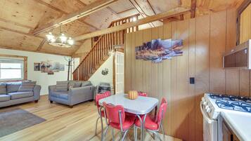 A wooden interior with a dining area, kitchen, and living space.