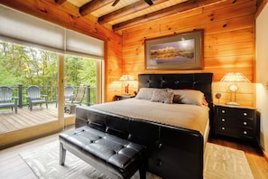 A bedroom with a large bed, a bench, a nightstand, and a window with a view of the outdoors. - Game Room, Hot Tub! Retreat 3 Mi to Holiday Valley (Ellicottville)