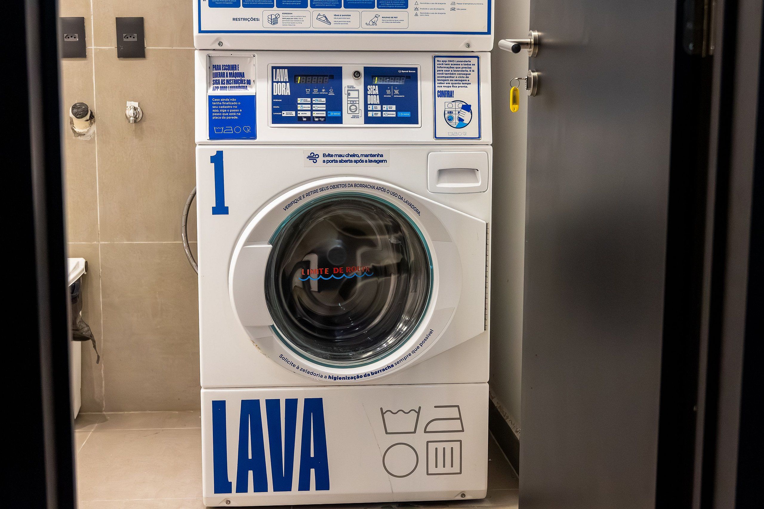 A front view of a white and blue laundry machine with a digital display and control panel.