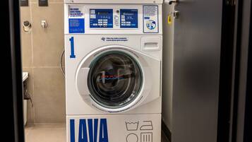 A front view of a white and blue laundry machine with a digital display and control panel.