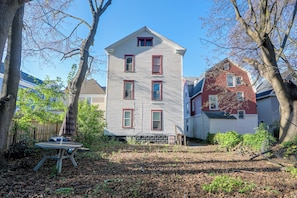 A two-story house with a gabled roof and a front porch. - Walk to Rosamond Gifford Zoo & Dining! Cozy Unit (Syracuse)