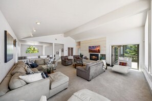 A spacious living area with a fireplace, sofas, and a television. - 225 Beach Drive 4 Bedroom Home (South Lake Tahoe)