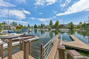 A marina with docked boats, a wooden pier, and residential buildings in the background. - 615 Alpine Drive 3 Bedroom Home (South Lake Tahoe)