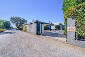 A gated entrance to a property with a sign indicating 'BARBATI BEACHFRONT POOL VILLA'. - Villa Grand Barbati Beach by Villa Plus (Mparmpati)