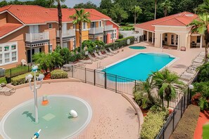 A resort with a swimming pool, multiple buildings, and a fountain. - 3BR Lake Berkley Pool Home Near Disney (Kissimmee)