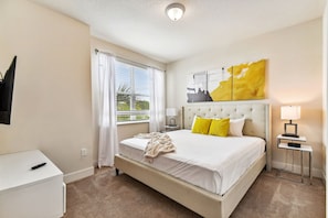A hotel room with a bed, bedside tables, a lamp, and a window with curtains. - Hf-17528 - 4br/3ba Modern Home Private Pool (Clermont)