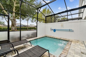 A covered outdoor swimming pool with benches, a pool ladder, and a safety sign on the wall. - Hf-17528 - 4br/3ba Modern Home Private Pool (Clermont)