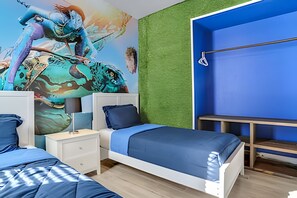A bedroom with a bed, two bedside tables, a dresser, and a mural on the wall. - Windsor Hills 5BR Luxury Pool & Game Room (Kissimmee)