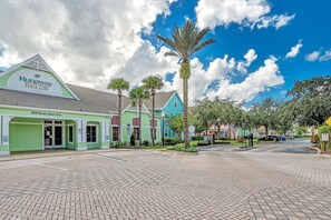 A street with a green building labeled 'Runaway Beach Club' at the corner. - 2BR condo near Disney | Resort pool (Kissimmee)