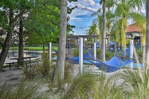 A beachside park with hammocks, a picnic table, and a gazebo. - Terra Verde Oasis Private Pool (Kissimmee)