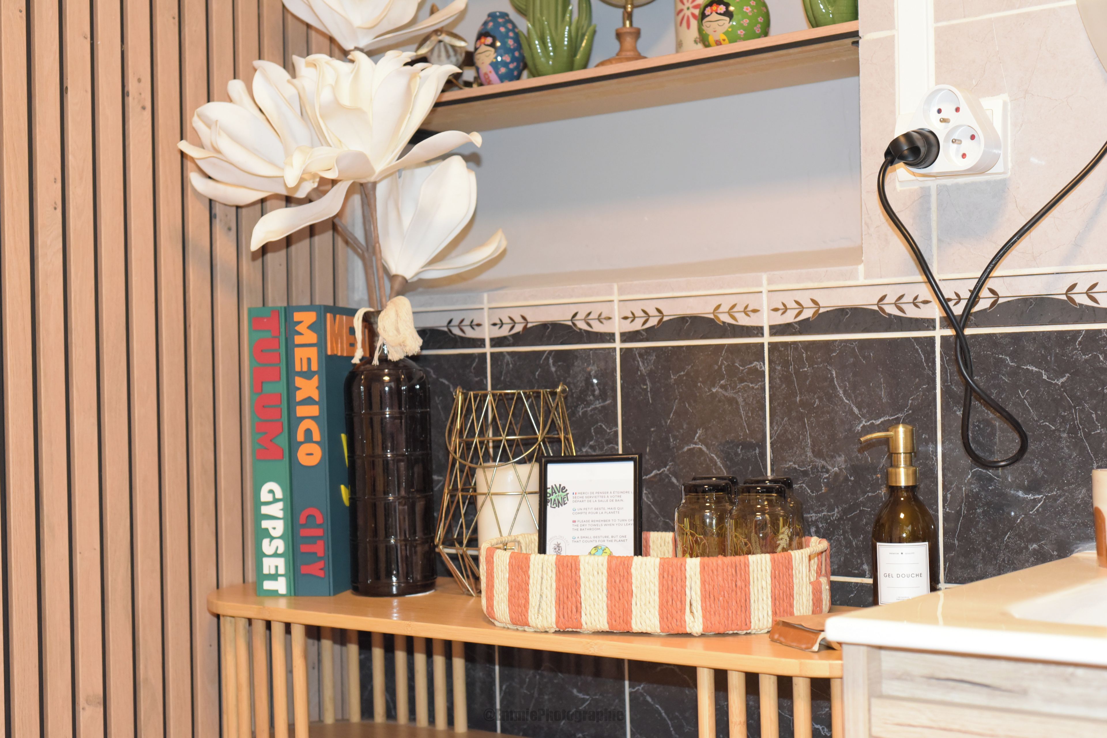 A kitchen counter with a book titled 'Mexico City' and a decorative vase.