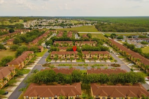 Um bairro residencial com várias casas de dois andares, dispostas em um padrão de grade com ruas entre elas.