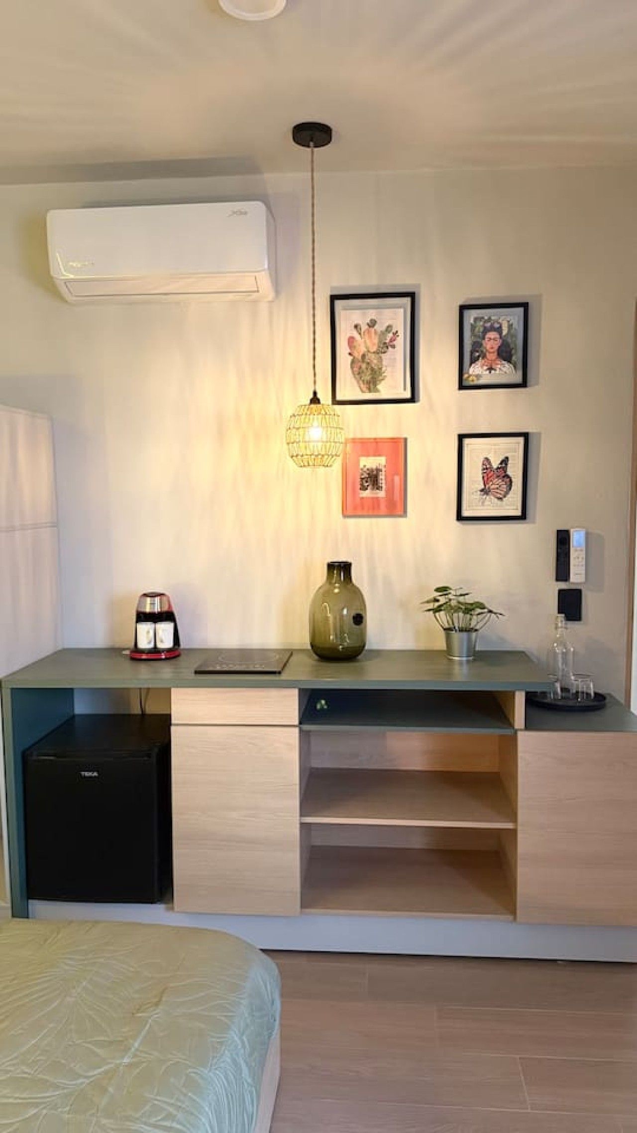 A modern kitchen with a built-in refrigerator, a coffee machine, and a vase on the counter.