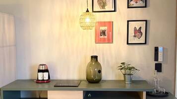 A modern kitchen with a built-in refrigerator, a coffee machine, and a vase on the counter.