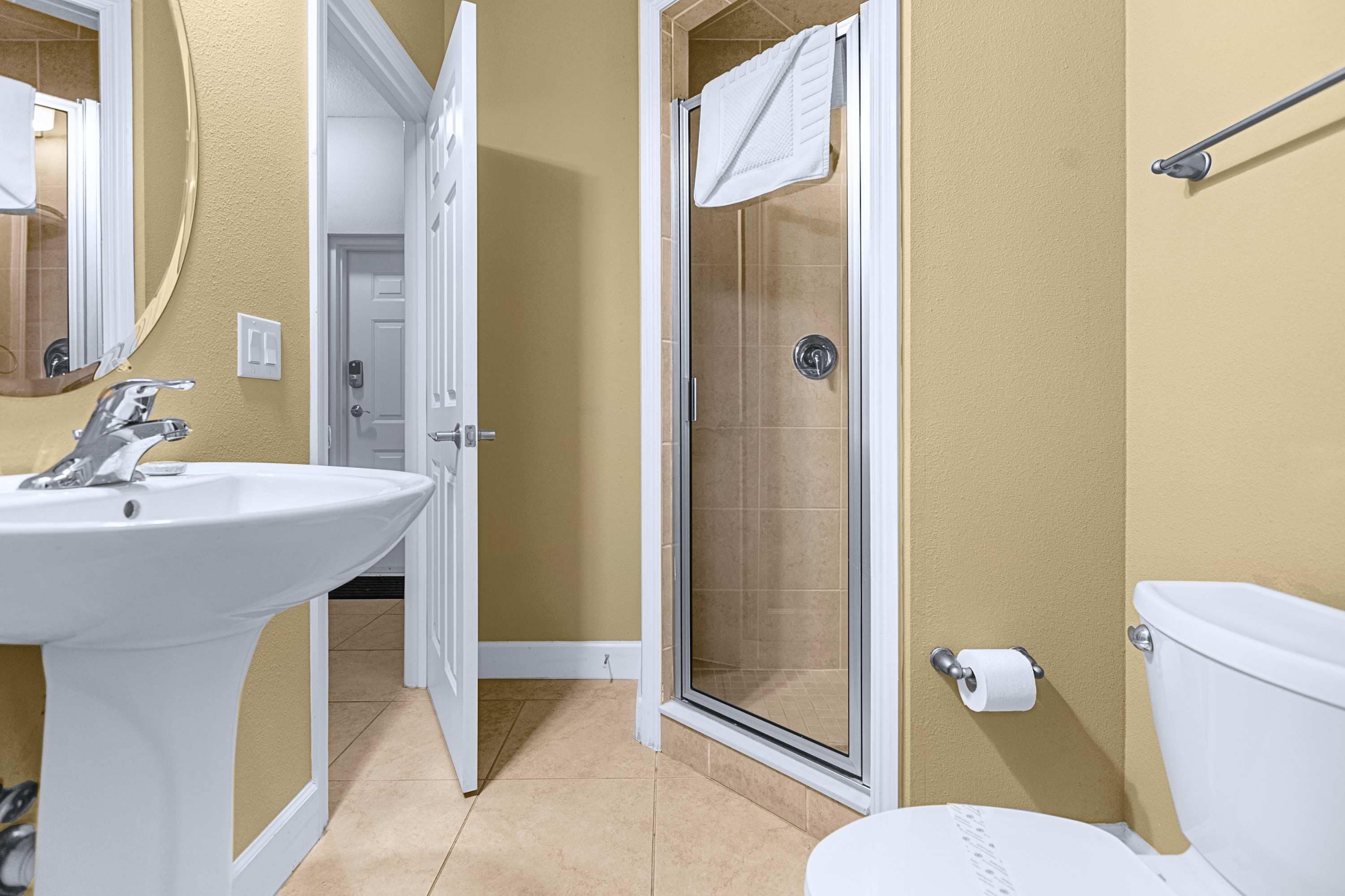 A bathroom with a sink, toilet, and shower.