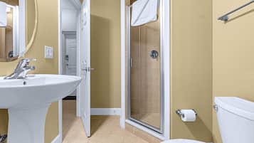 A bathroom with a sink, toilet, and shower.