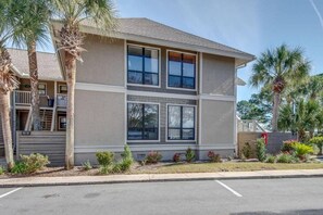 A two-story building with a flat roof, large windows, and a parking lot in front. - ☀️Bay Views | Close to Beach | Golf Cart (LSV) | Harbour Pointe 806☀️ (Miramar Beach)