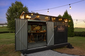 A metal structure with a sign reading 'Bourbon Pavilion' and a Kentucky Bourbon Trail map inside.