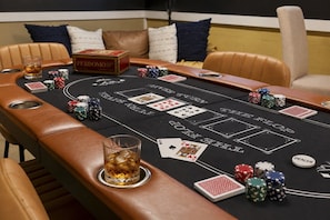 A craps table with chips, cards, and a dealer button.