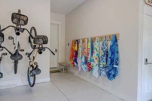 A hallway with a bicycle mounted on the wall and a row of colorful towels hanging on the wall. - Luxury Stay on 30A- Gym, Bikes & Custom Golf Cart! (Inlet Beach)