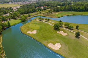 A golf course with multiple bunkers and a water body. - Luxury 3BR 2.5BA Townhome w/Resort Perks (North Myrtle Beach)
