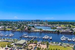 A marina with boats docked, a waterfront promenade, and buildings in the background. - Luxury 3BR 2.5BA Townhome w/Resort Perks (North Myrtle Beach)