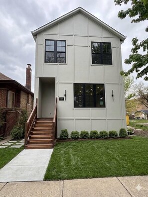 A two-story building with a front entrance, a staircase, and a small front yard. - The Oak Park Casa Oasis | 6BR + Fireplace (Oak Park)