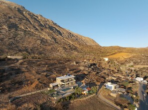 A modern two-story building with a swimming pool, surrounded by a hilly landscape. - Aelia Private Villa Triopetra (Unknown)