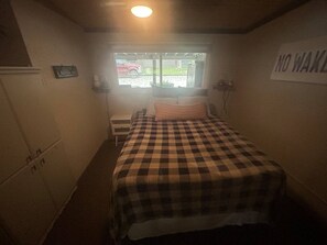 A small room with a bed, a window, and a 'NO WAKING' sign on the wall. - Portland Mills Ramp Drive (Greencastle)