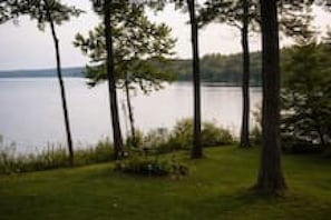 A lakeside view with trees and a grassy area. - Lakeview Cabin | Dock, Fire Pit & Screened Porch (Greencastle)