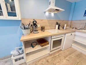 A modern kitchen with a built-in oven, a coffee maker, and a sink. - Charming duplex near beach - 6 guests (Cabourg)