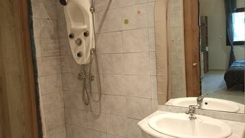 A bathroom with a bathtub, a shower, and two sinks.