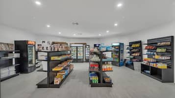 A clean, well-lit grocery store with organized shelves stocked with various products.