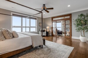 A bedroom with a large bed, a ceiling fan, and a view of the outdoors. - Mtn Views, Game Room, Fire Table, Porches (Blowing Rock)