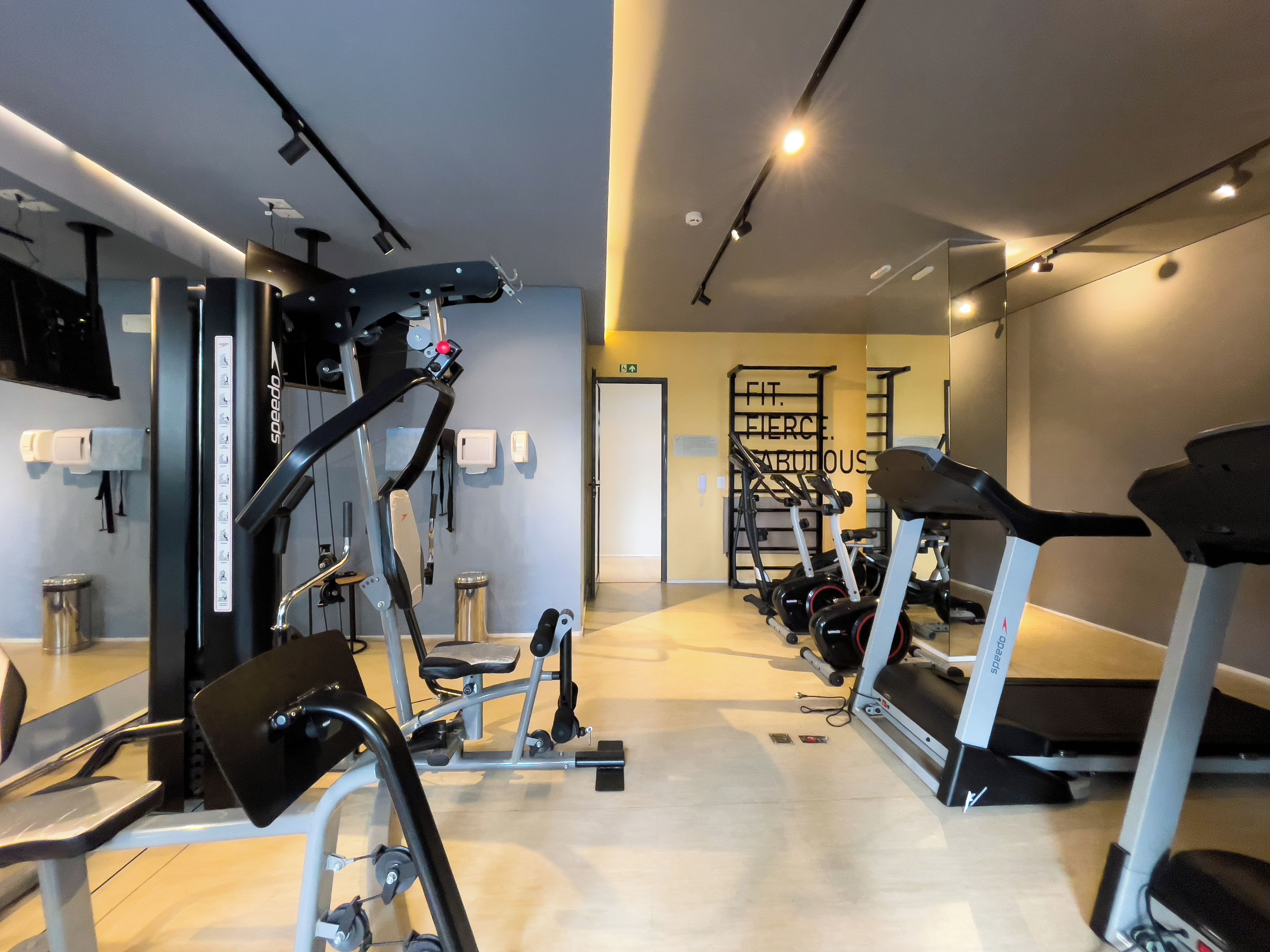 A gym with various exercise equipment, including treadmills and weight machines.
