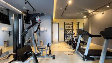 A gym with various exercise equipment, including treadmills and weight machines.