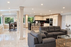 A modern interior with a dining area, kitchen, and living space. - Lake Ontario Waterfront Retreat | Private Dock (Pickering)
