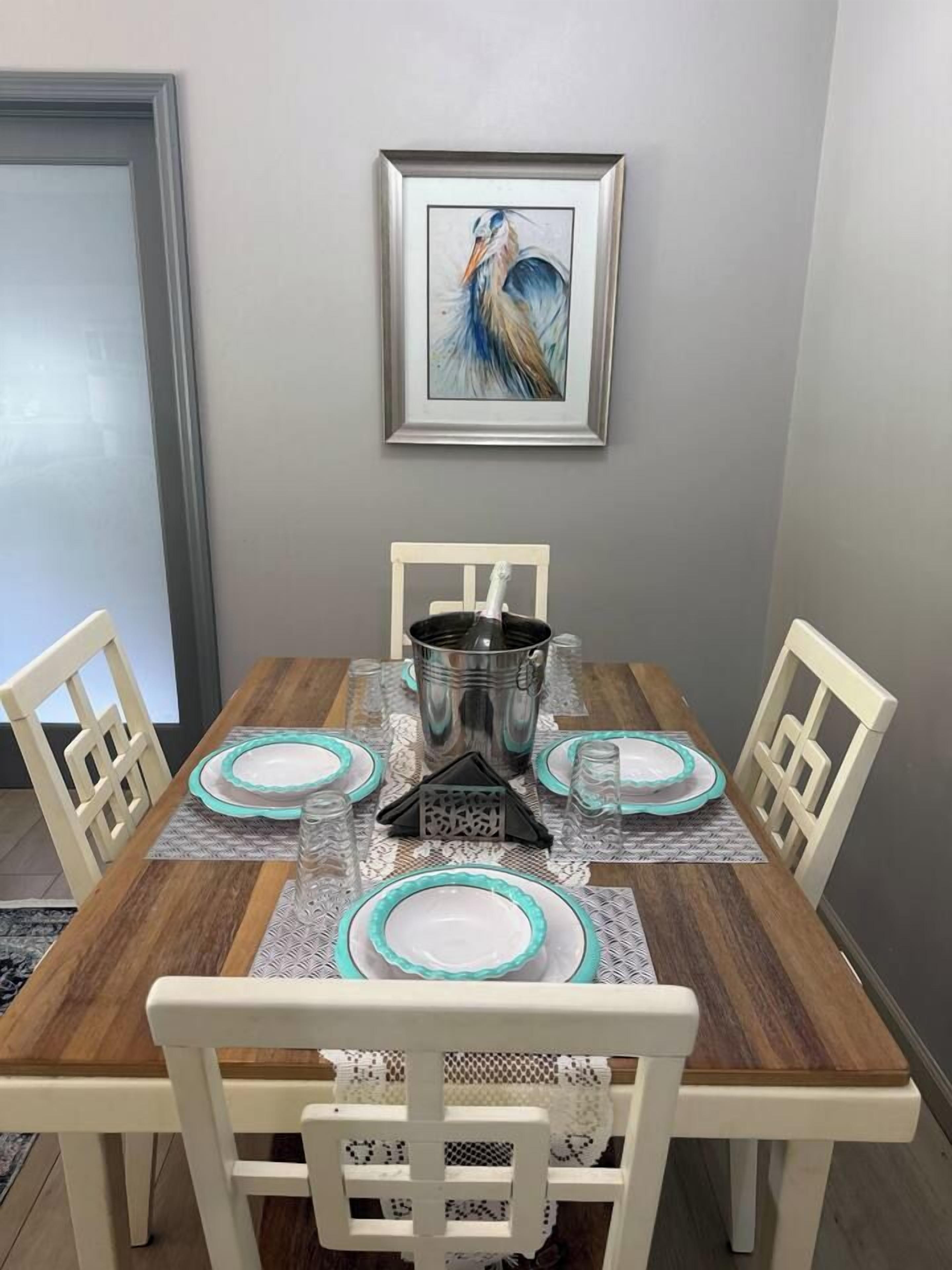 A dining table set with plates, a pitcher, and a glass.