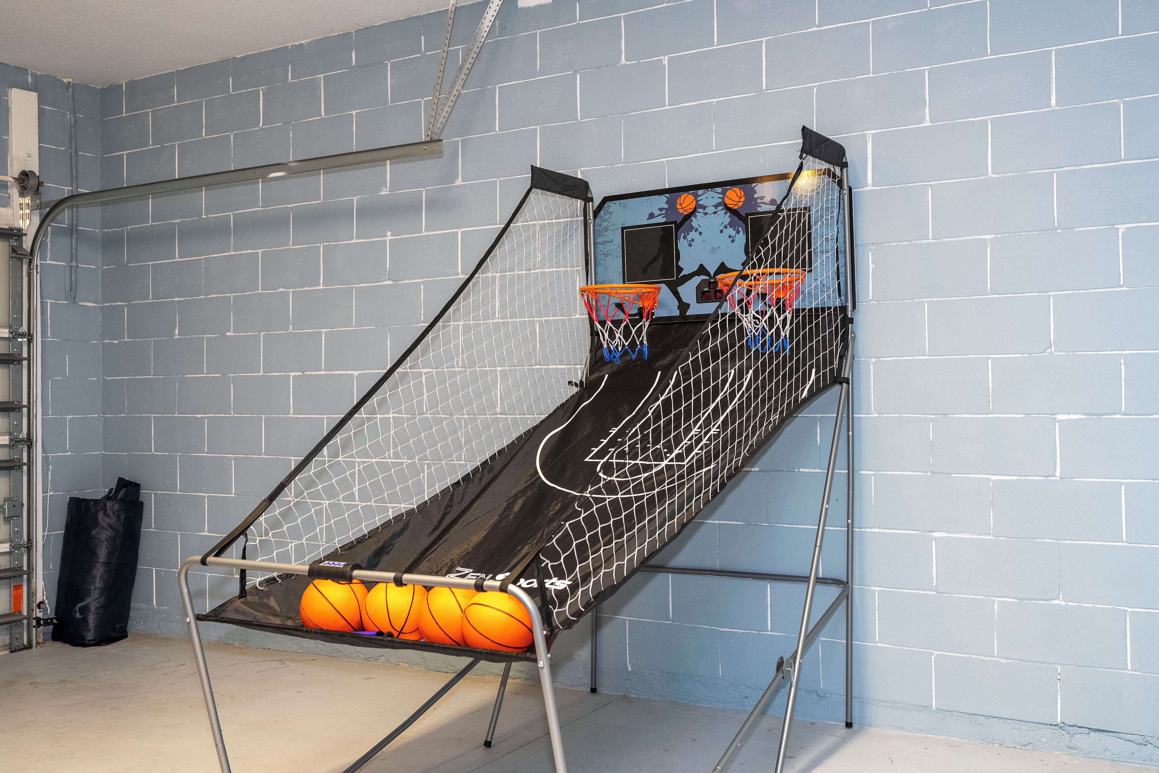 Un canestro da basket con rete, fissato a una parete con mattoni.