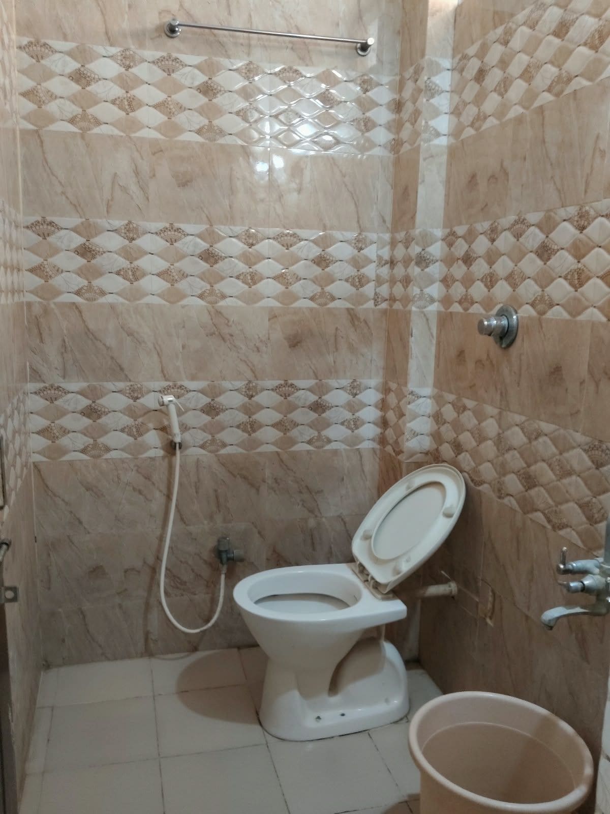 A bathroom with a toilet, a shower, and a sink.