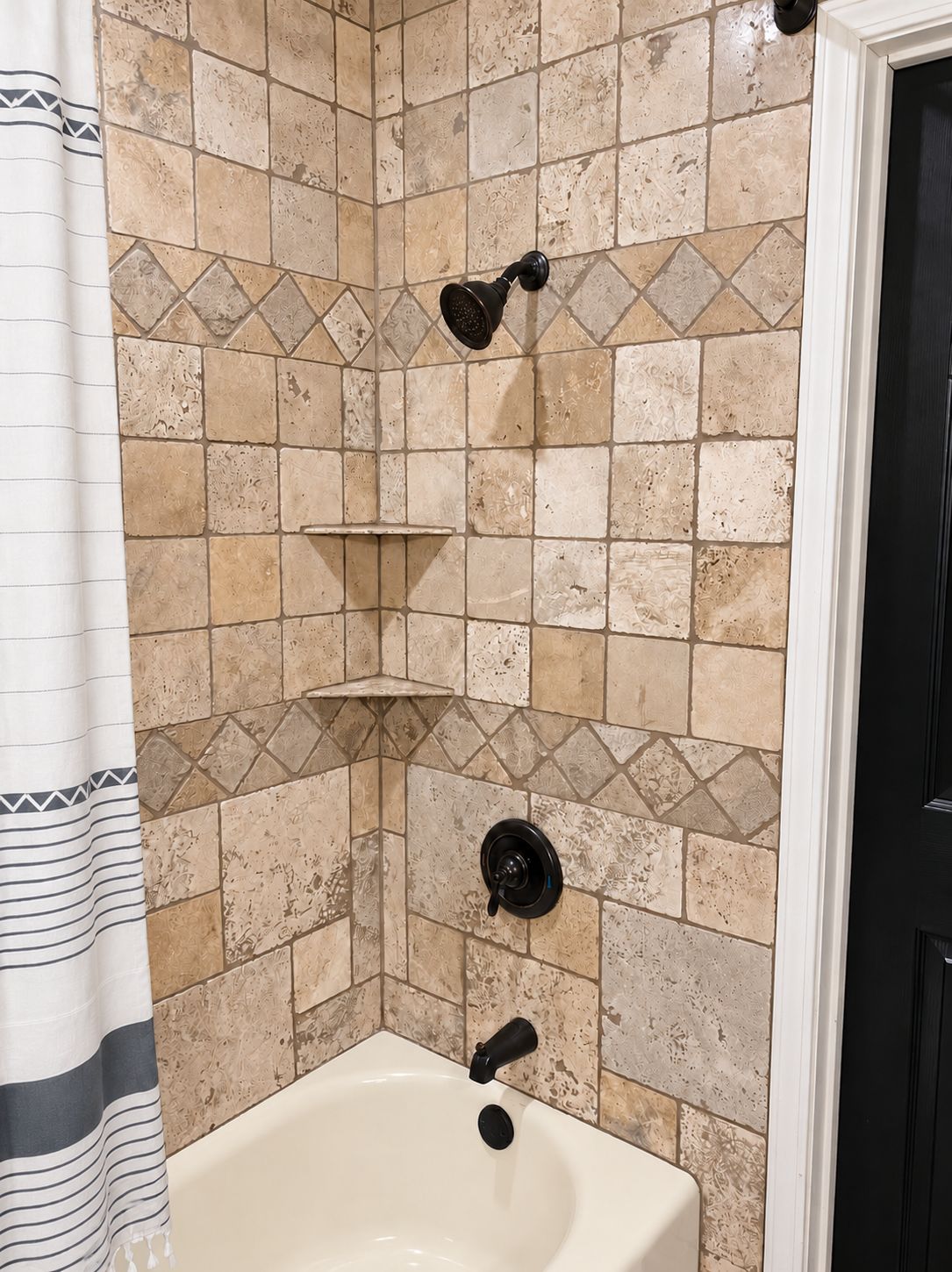A bathroom with a bathtub, a showerhead, and a towel rack.