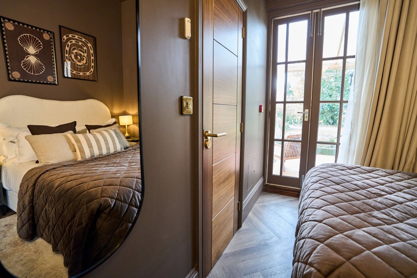 Comfortable king size bed with quality linens and soft furnishings, patio doors leading to your private terrace