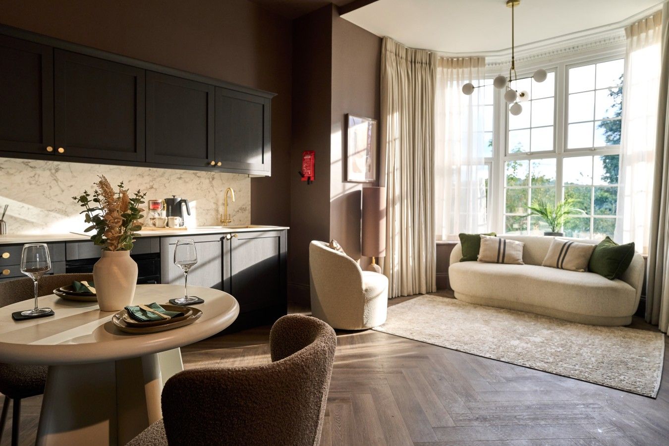 Modern and luxurious living space, dining area, full kitchen and garden views