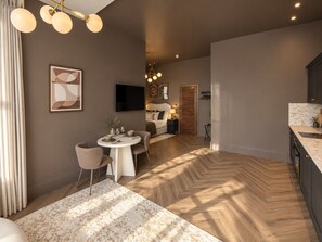 Un interior modern amb zona de menjador, cuina i dormitori.