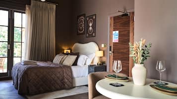Spacious suite with king size bed, dining space, and doors to your private terrace
