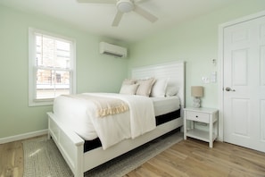 A bedroom with a bed, bedside table, nightstand, and a ceiling fan. - Walk to Roger Wheeler Beach - Water Views (Narragansett)