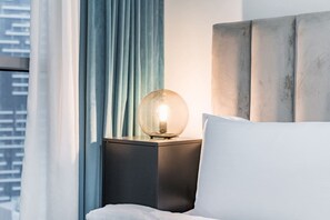 A hotel room with a bed, a nightstand, a lamp, and a view of the city. - FIRST CLASS | 2BR | Burj View | Premium City Stay (Dubai)